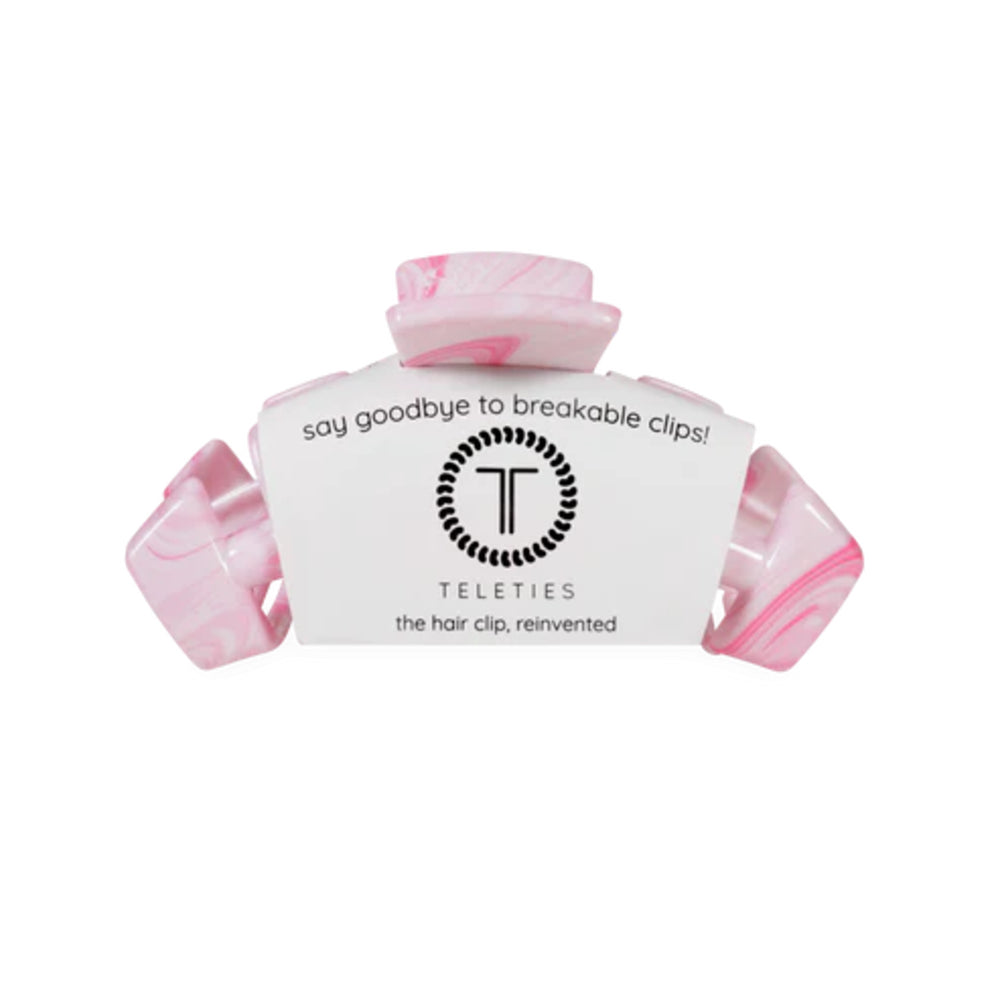 Pink hair clip with white label on a white background