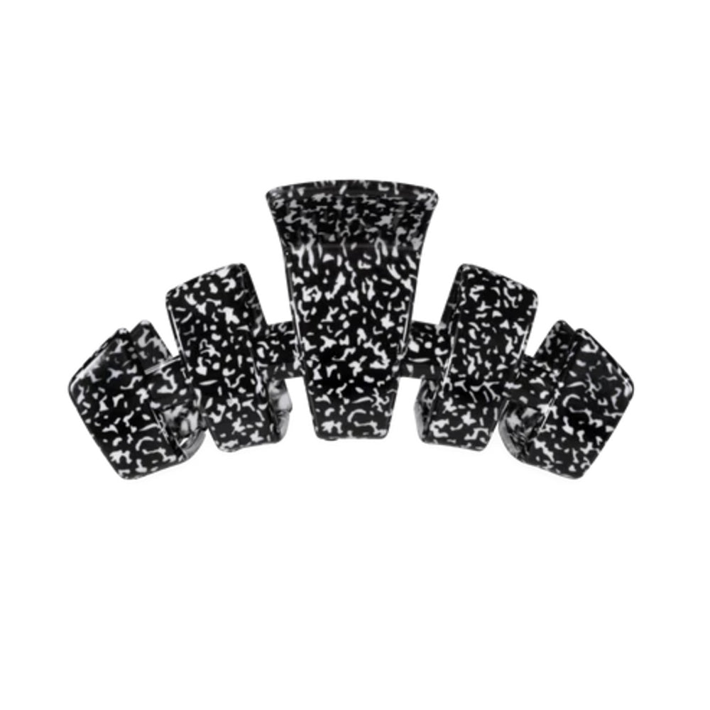 A black and white marbled or speckled hair claw clip shown against a plain white background.