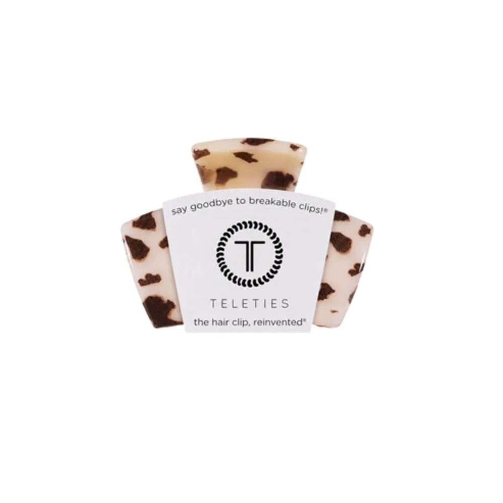 A Teleties hair clip in a leopard print pattern, featuring a white paper label with the brand logo and name, set against a plain white background.