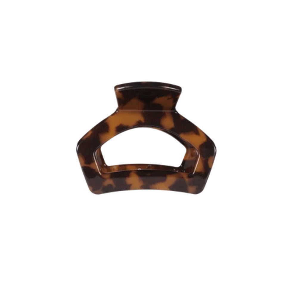 A tortoiseshell hair claw clip with a glossy brown and amber pattern, shown against a plain white background.