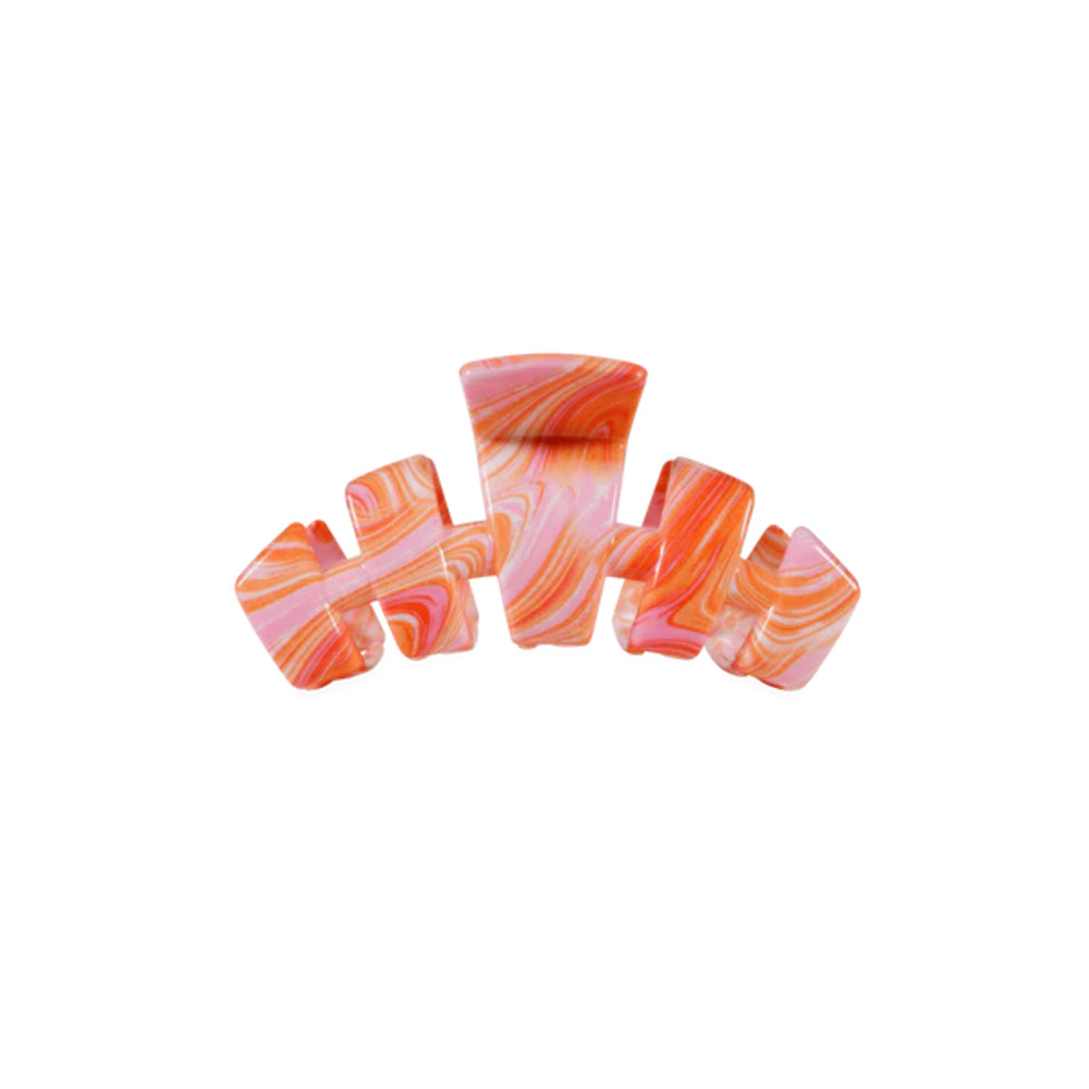 Set of a colorful hair clip with pink and orange marbled pattern on a white background