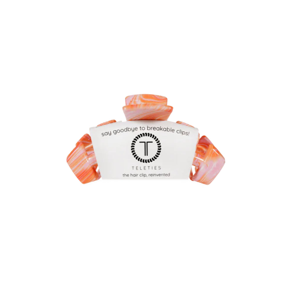 Marble-patterned hair clip with Teleties branding on a white background