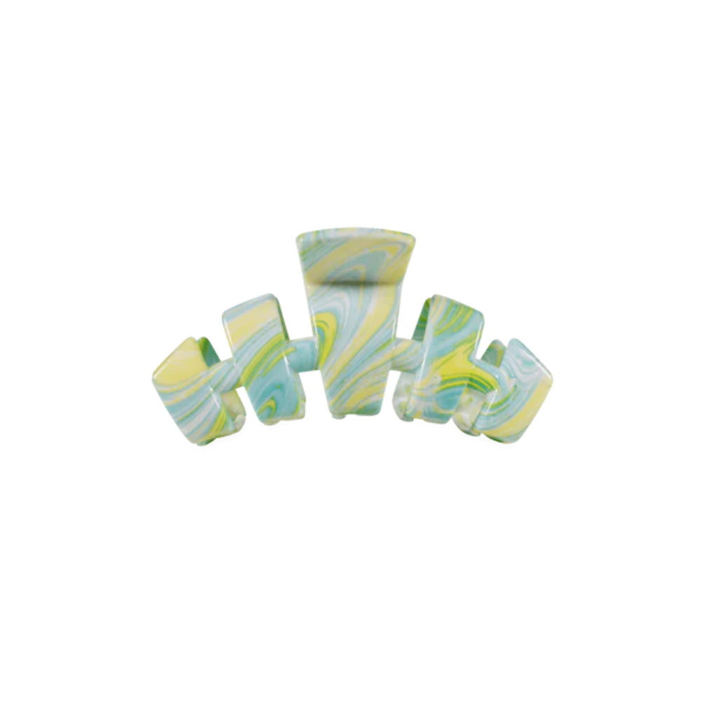 Marbled green and white hair clip on a white background