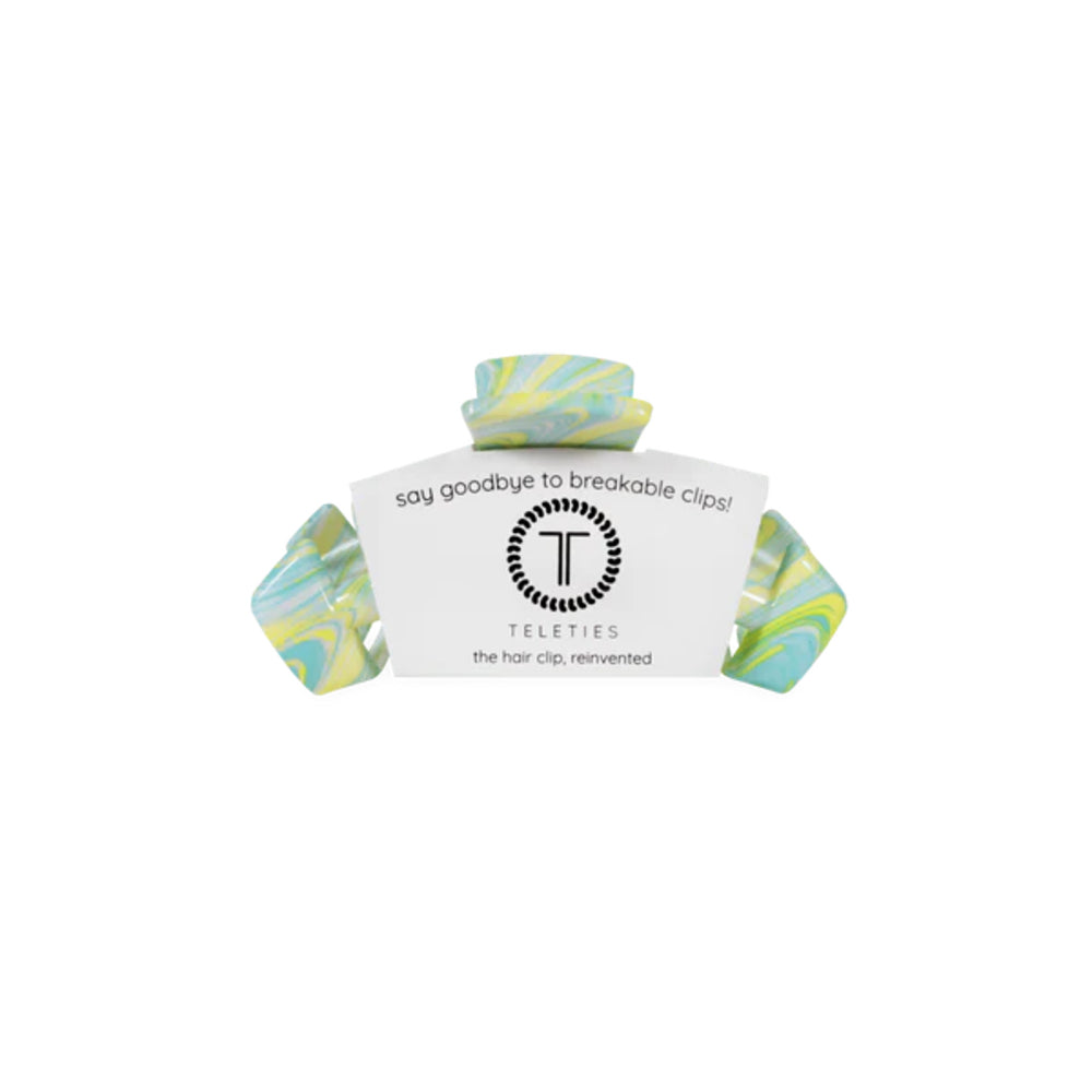 Marbled green and blue hair clip with a white card displaying 'Teleties' brand on a white background.