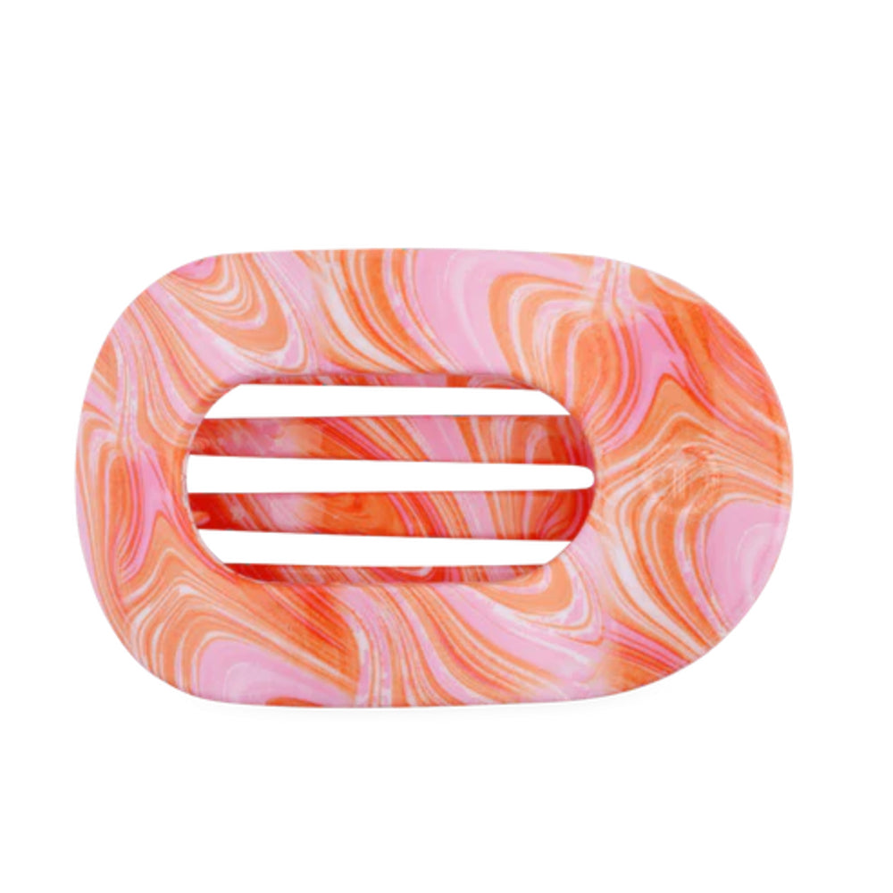 Marbled pink and orange hair clip on a white background