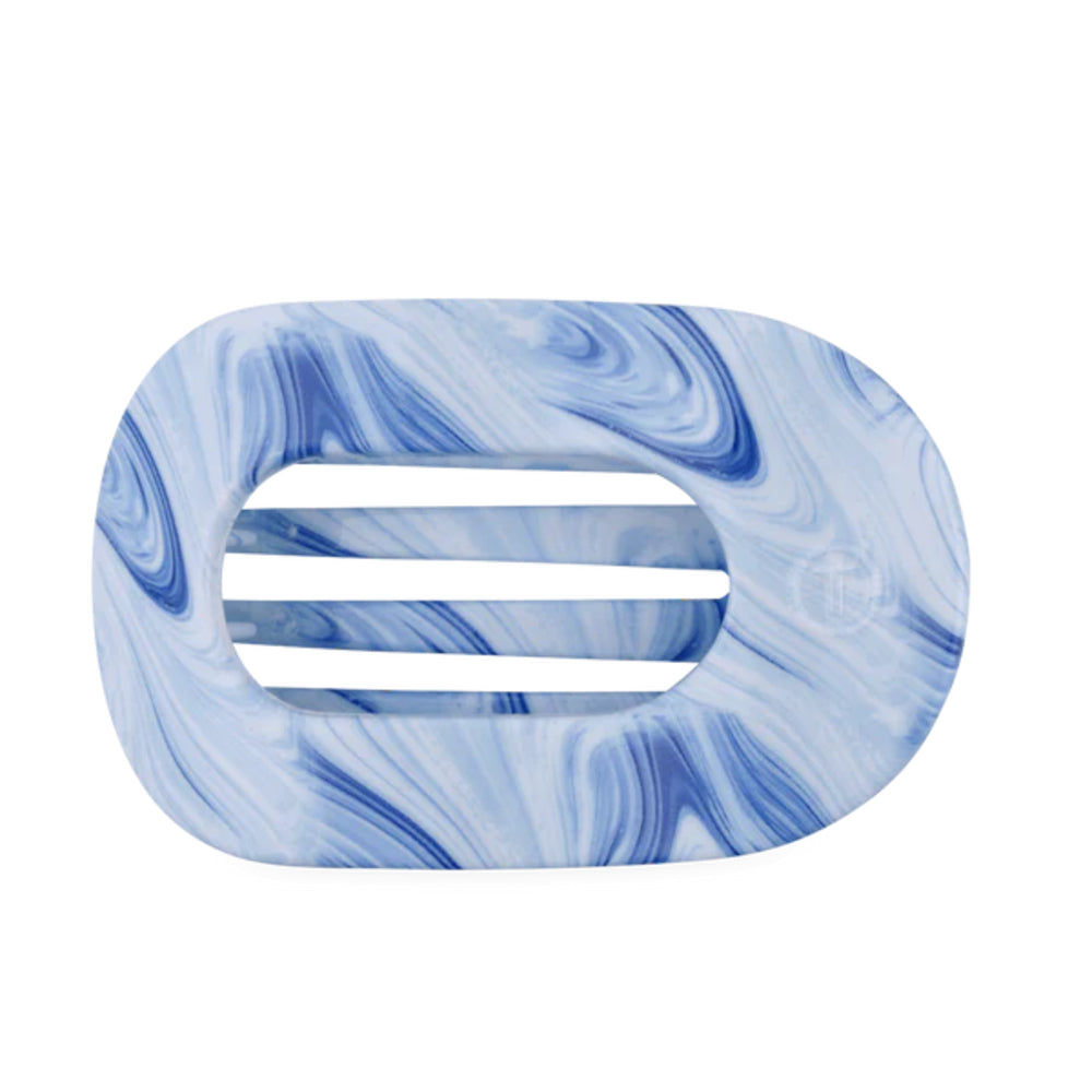 Blue and white marbled hair clip on a white background