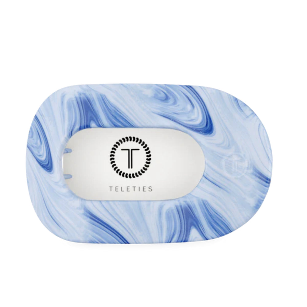 Marble-patterned hair clip with 'Teleties' branding on a white background
