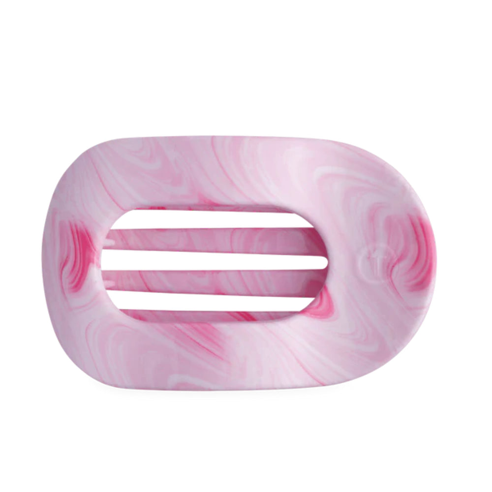 Pink and white marbled hair clip on a white background