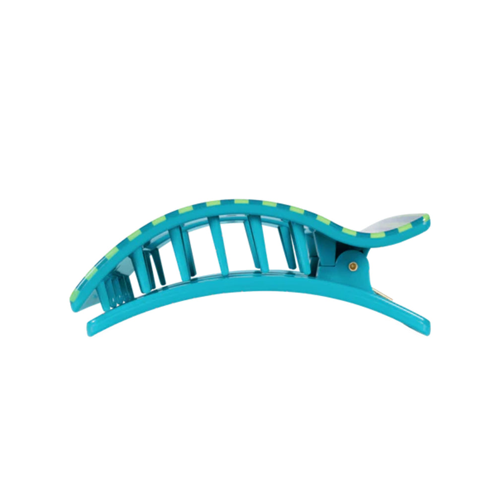 Turquoise hair clip with green accents on a white background