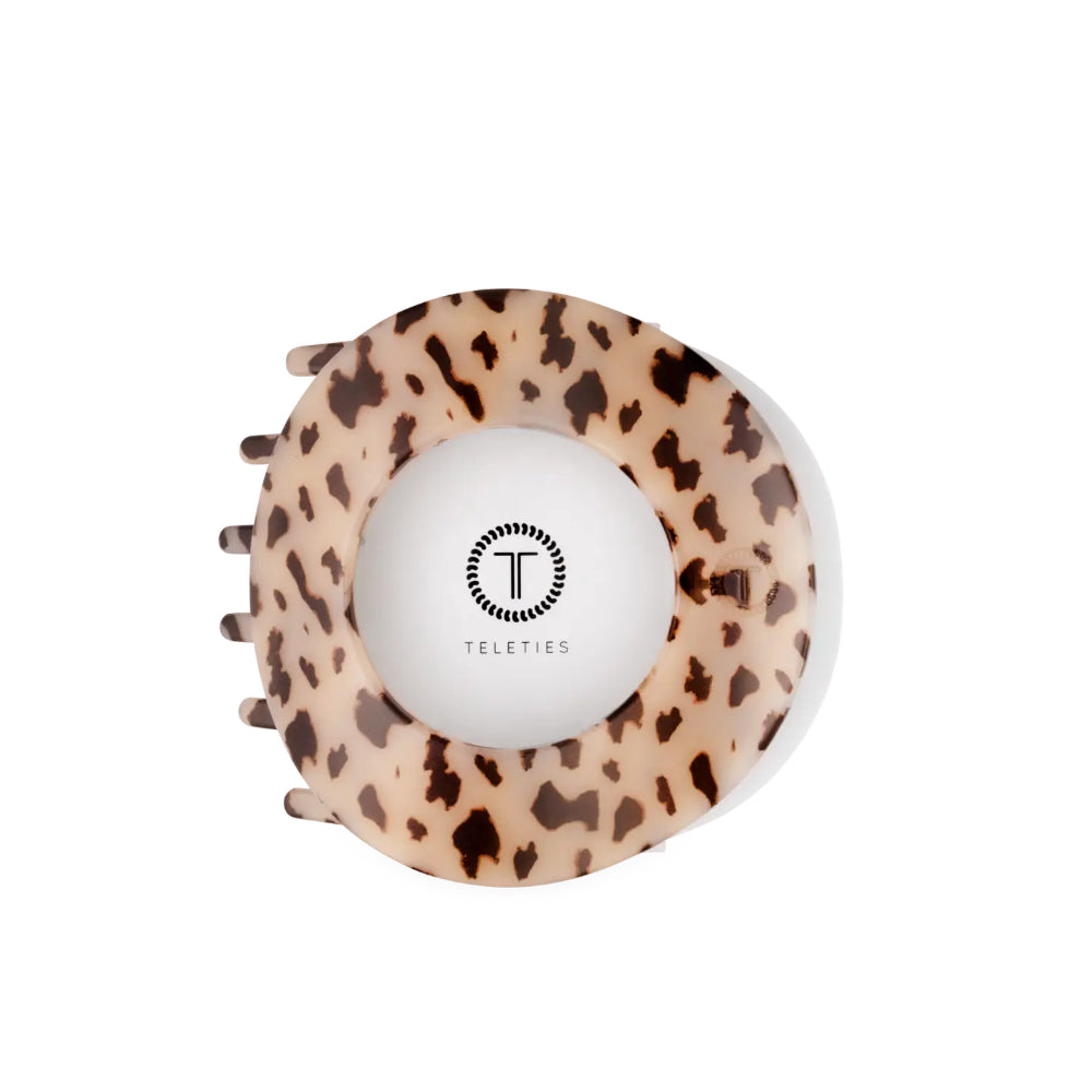 A large blonde tortoise hair clip on a white background. 