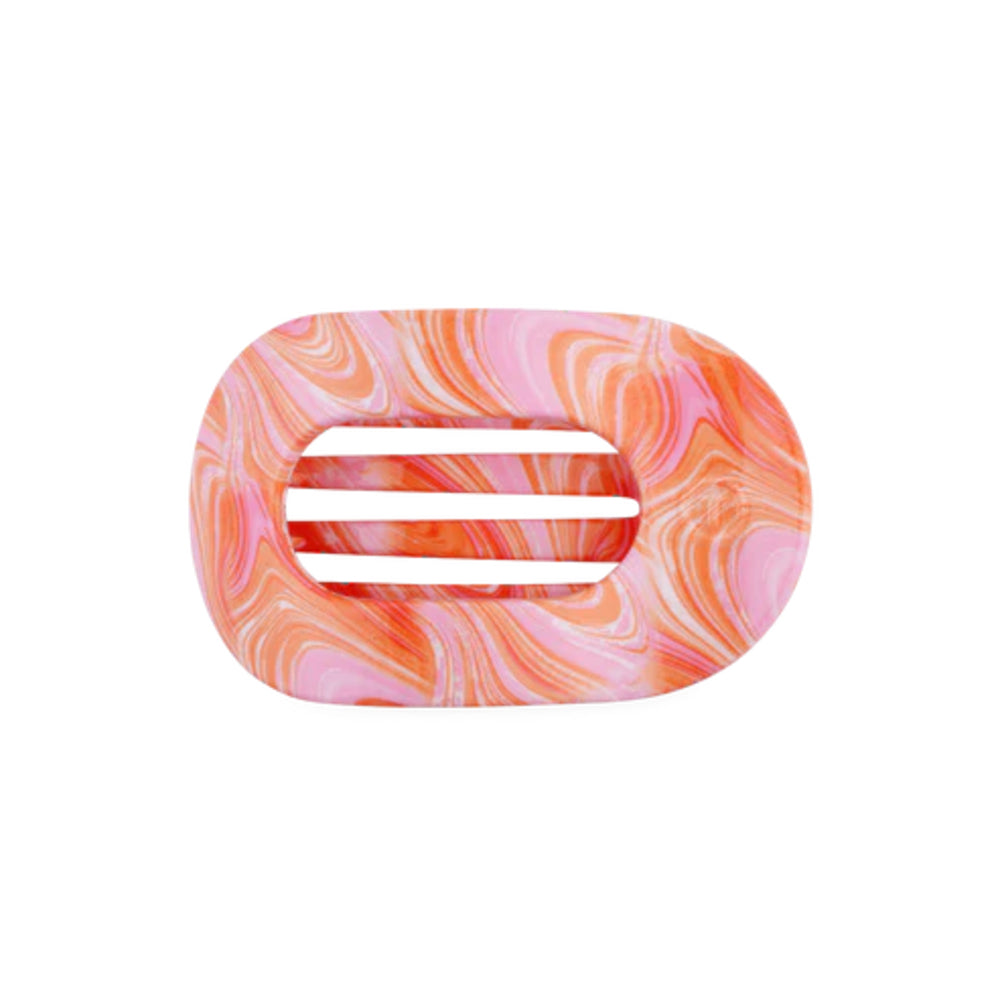 Marbled pink and orange hair clip on a white background
