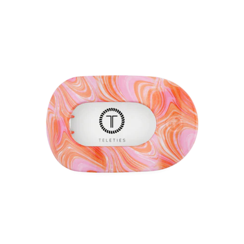Marbled pink and orange hair clip with Teleties logo on a white background