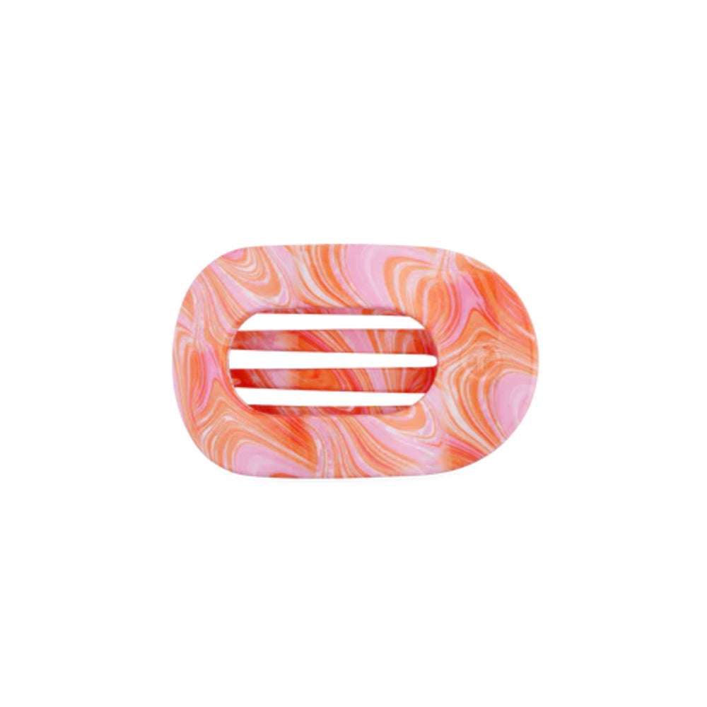 Marbled pink and orange hair clip on a white background
