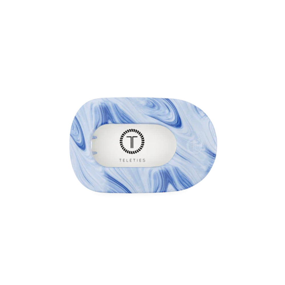 Marble-patterned hair clip with 'Teleties' branding on a white background