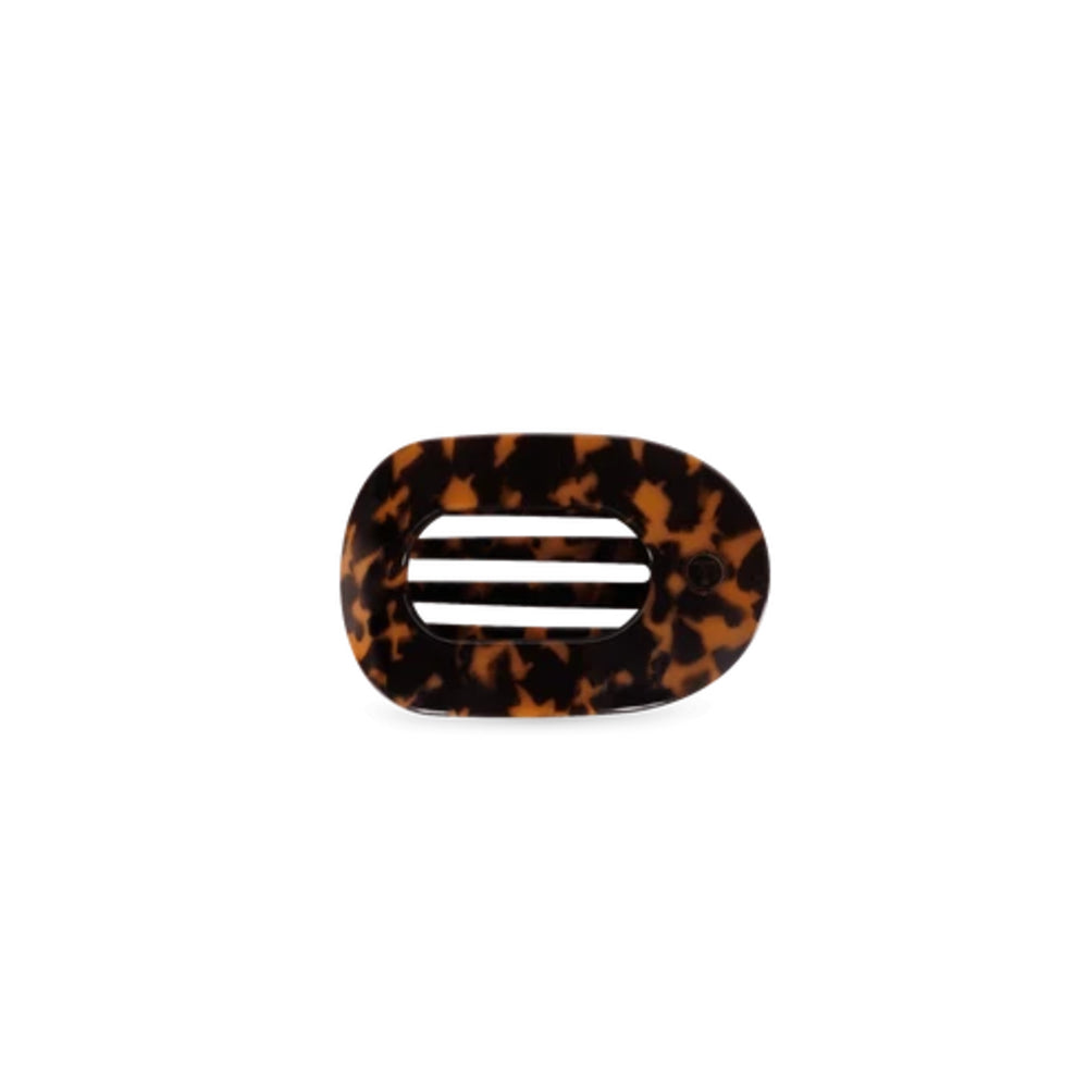 A tortoiseshell hair clip with a glossy finish and three horizontal white slits, shown on a plain white background.