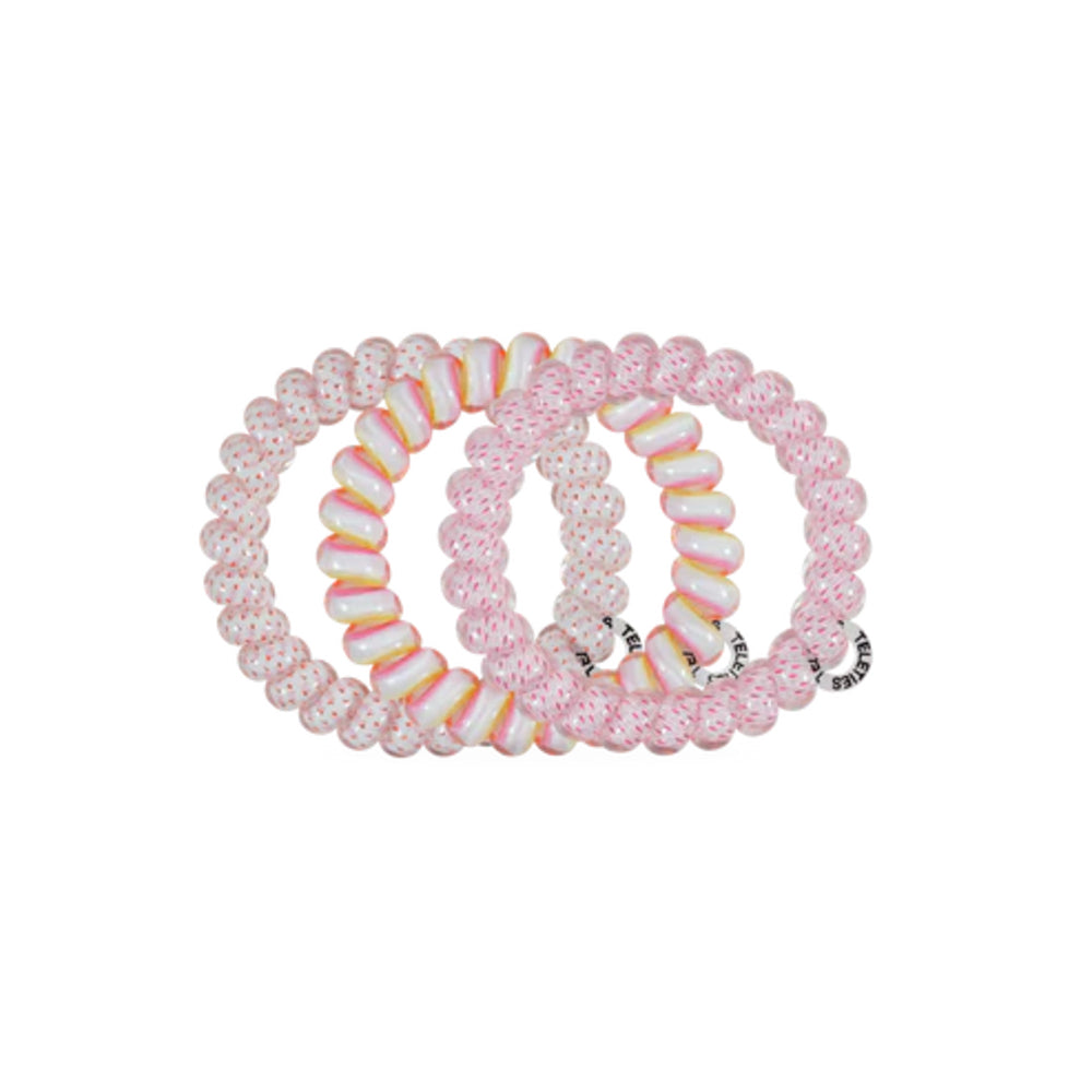 Set of pink and white spiral hair ties on a white background