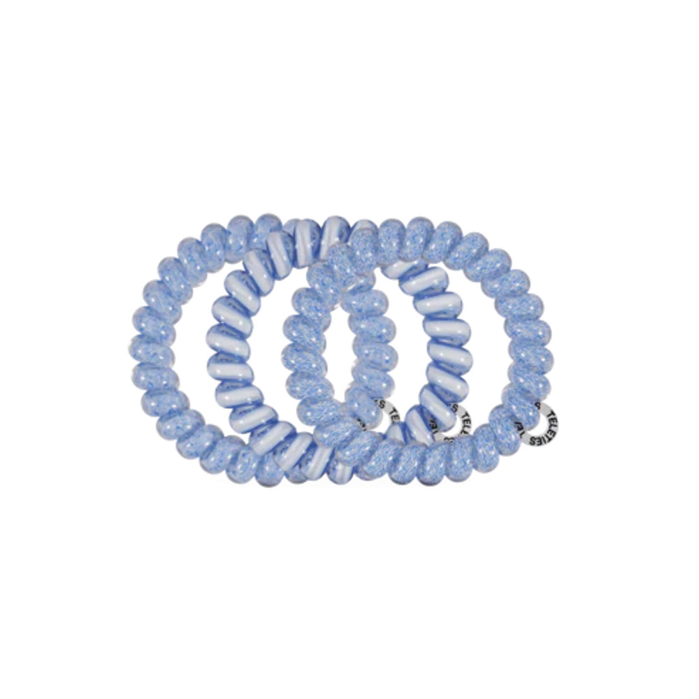 Set of blue and white spiral hair ties on a white background