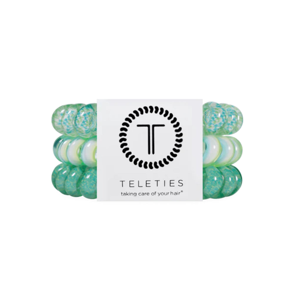 Green hair ties with a Teleties branded label on a white background