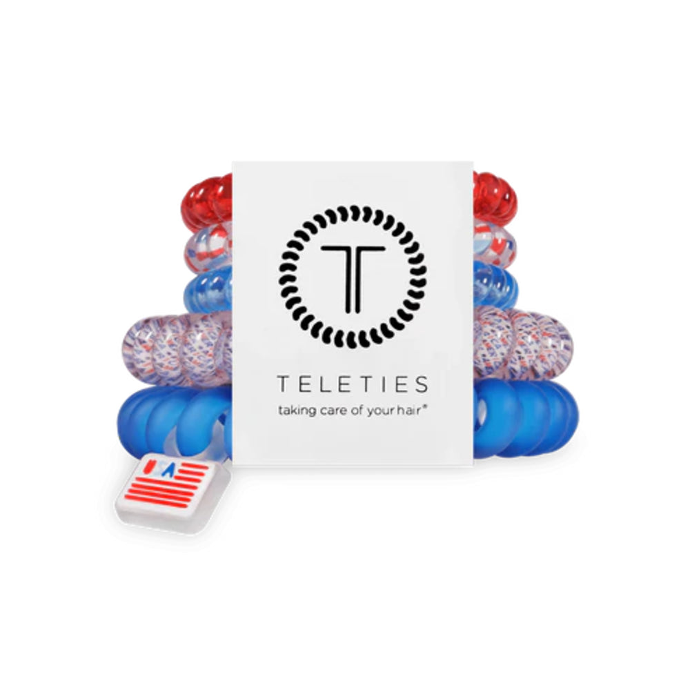 Set of colorful hair ties with a Teleties branded box on a white background