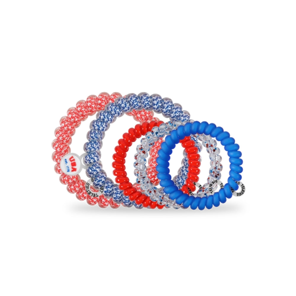 Set of red, white, and blue hair ties on a white background