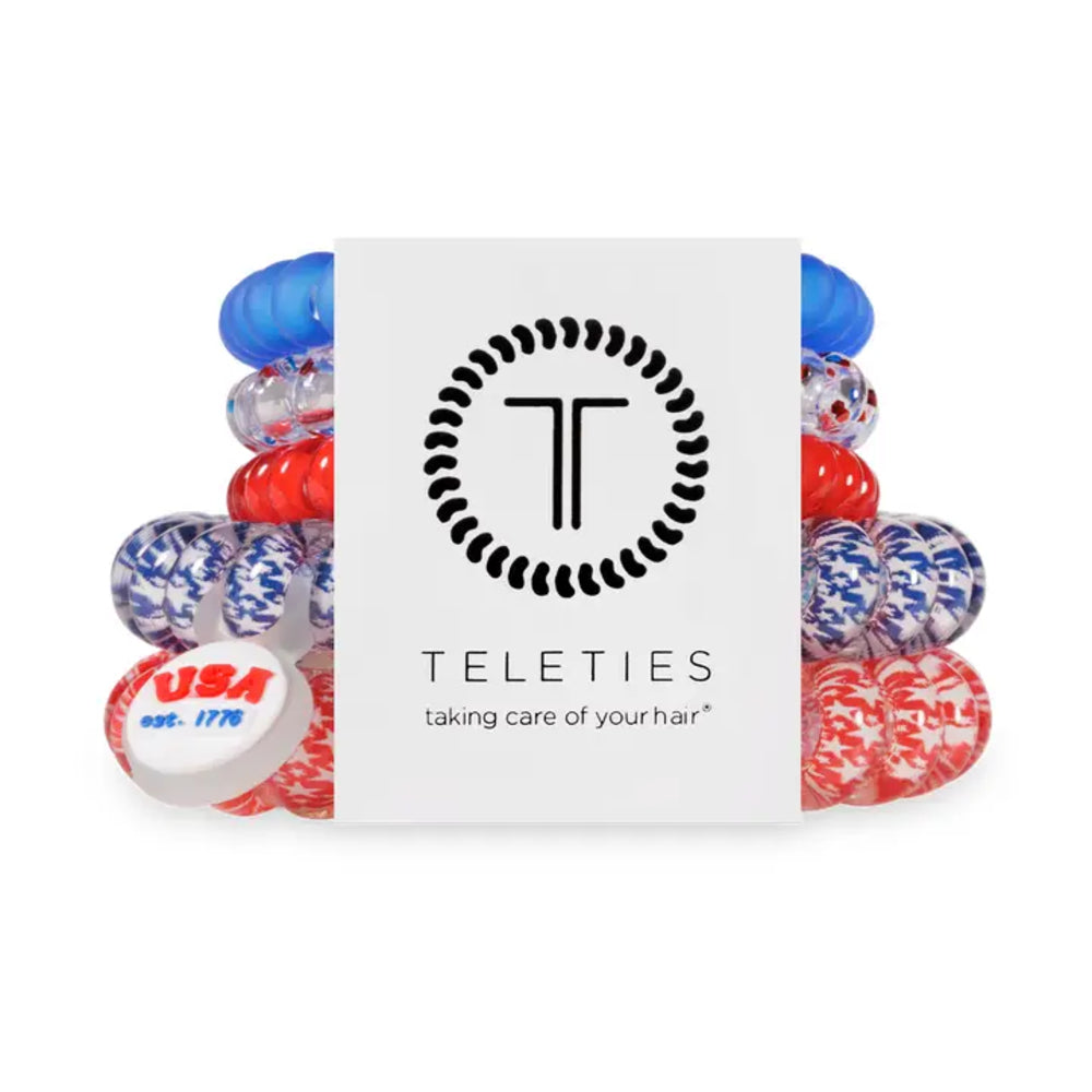 Set of colorful hair ties with a Teleties branded card on a white background