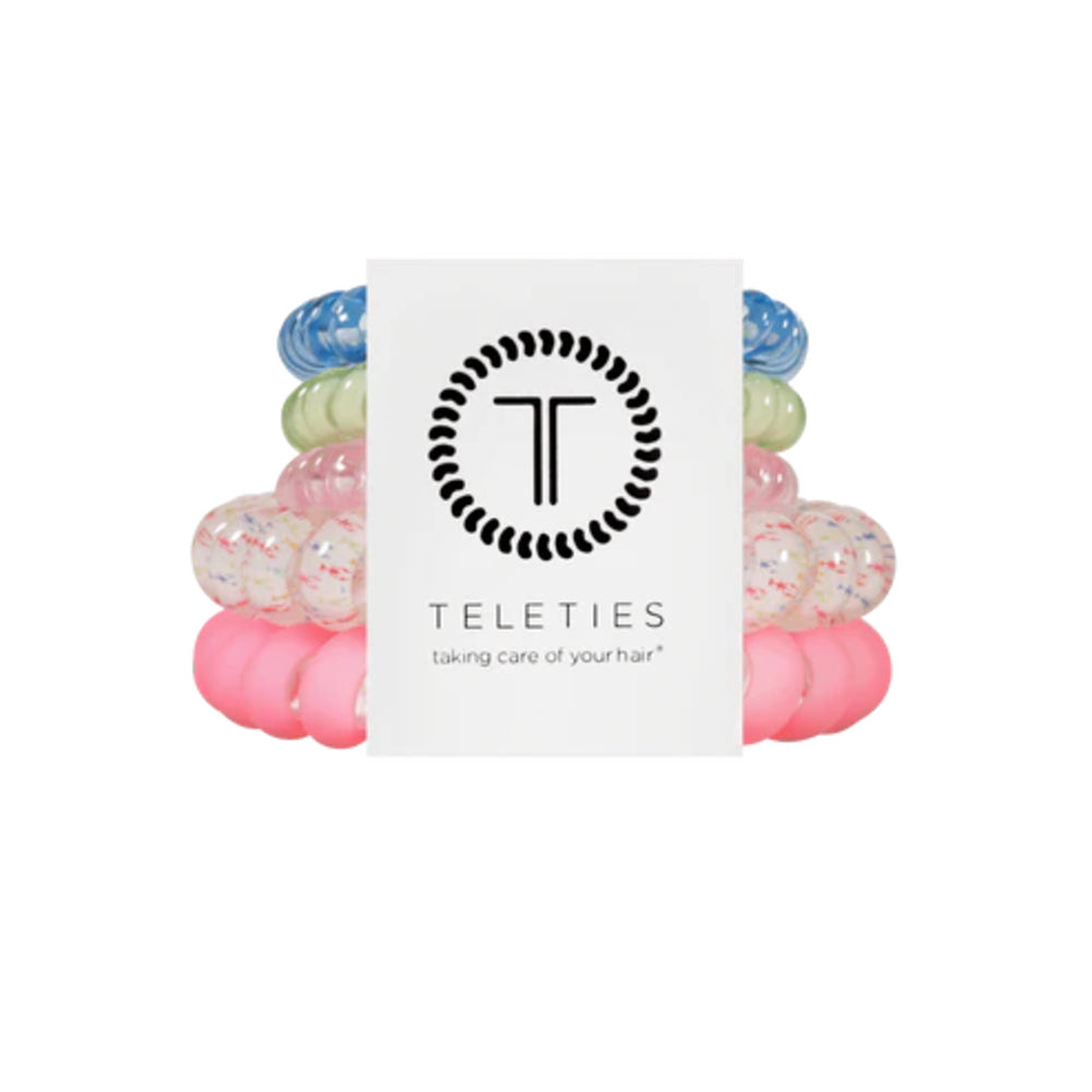 Stack of colorful hair ties with a Teleties branded card on a white background