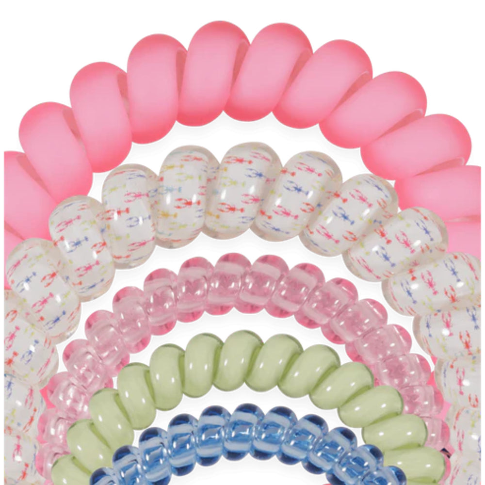 Set of colorful spiral hair ties on a white background