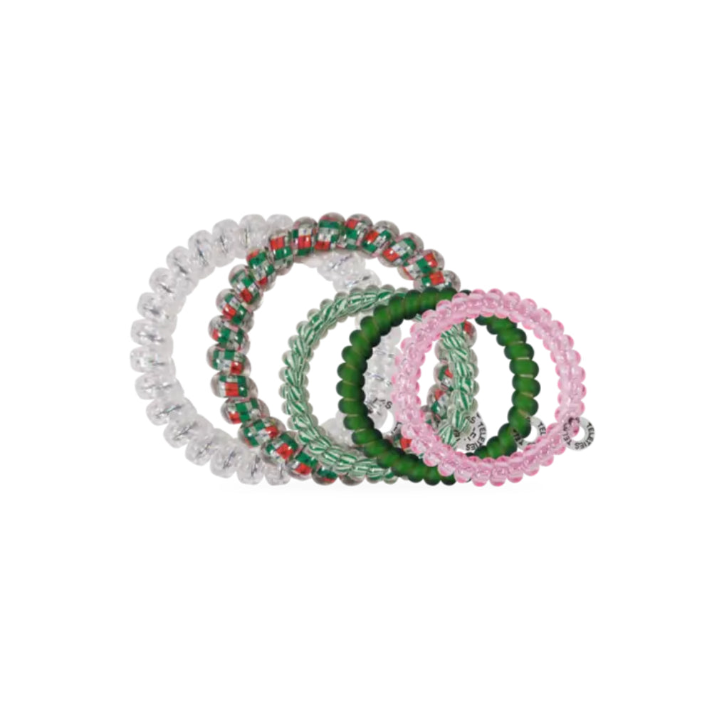 A set of five beaded elastic hair ties in white, green, pink, and red-and-green patterns, arranged in an overlapping fan shape on a plain white background.