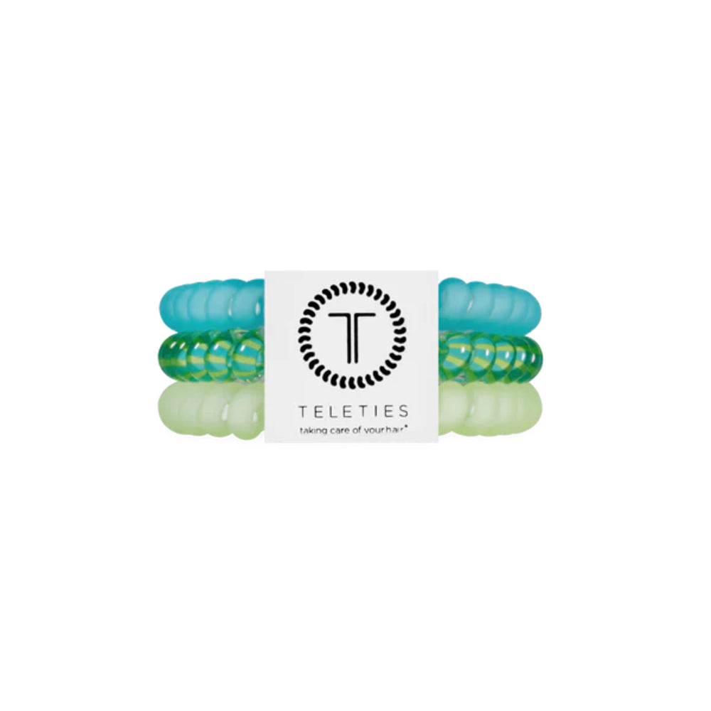 Set of green hair ties with a Teleties branded card on a white background