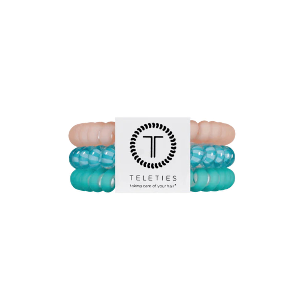 Turquoise hair ties with a brand label on a white background