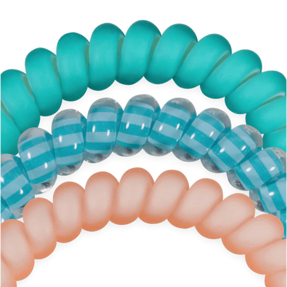 Turquoise, clear, and peach coil hair ties on a white background