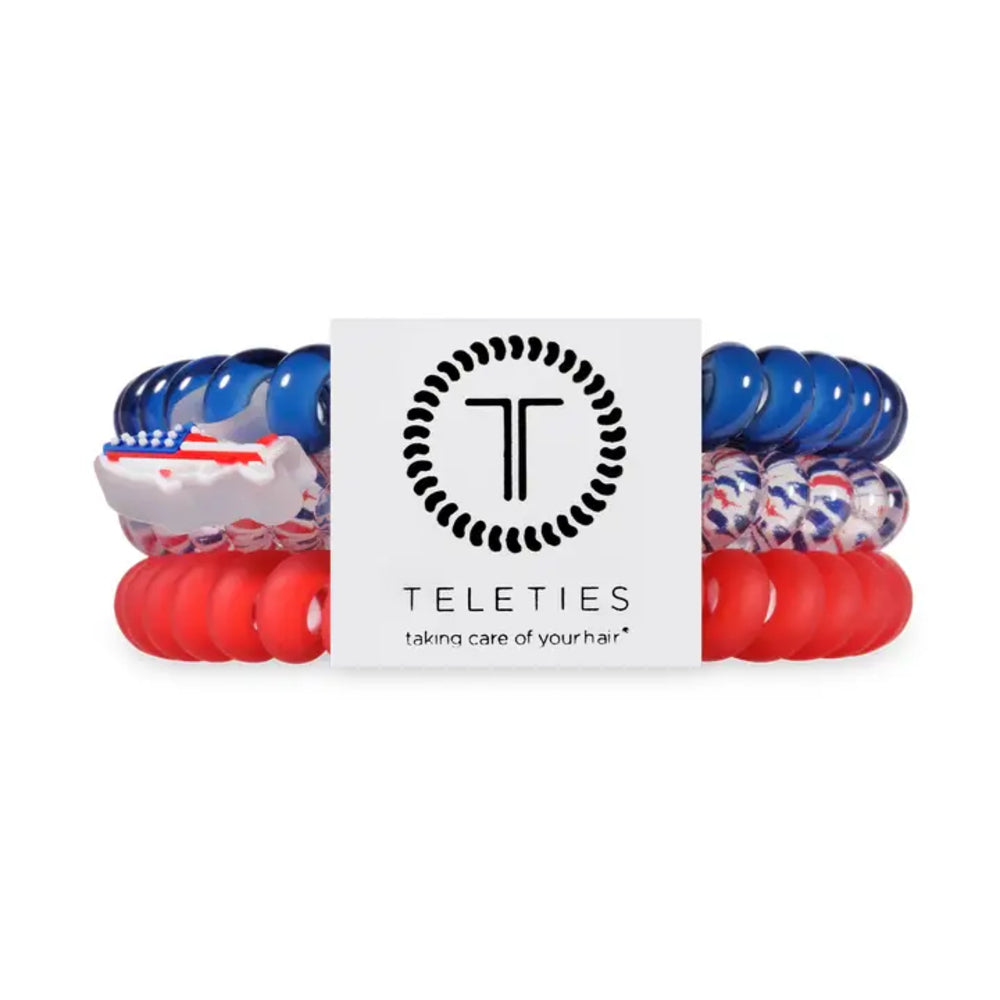Set of blue, red, and white hair ties with Teleties logo in the center on a white background