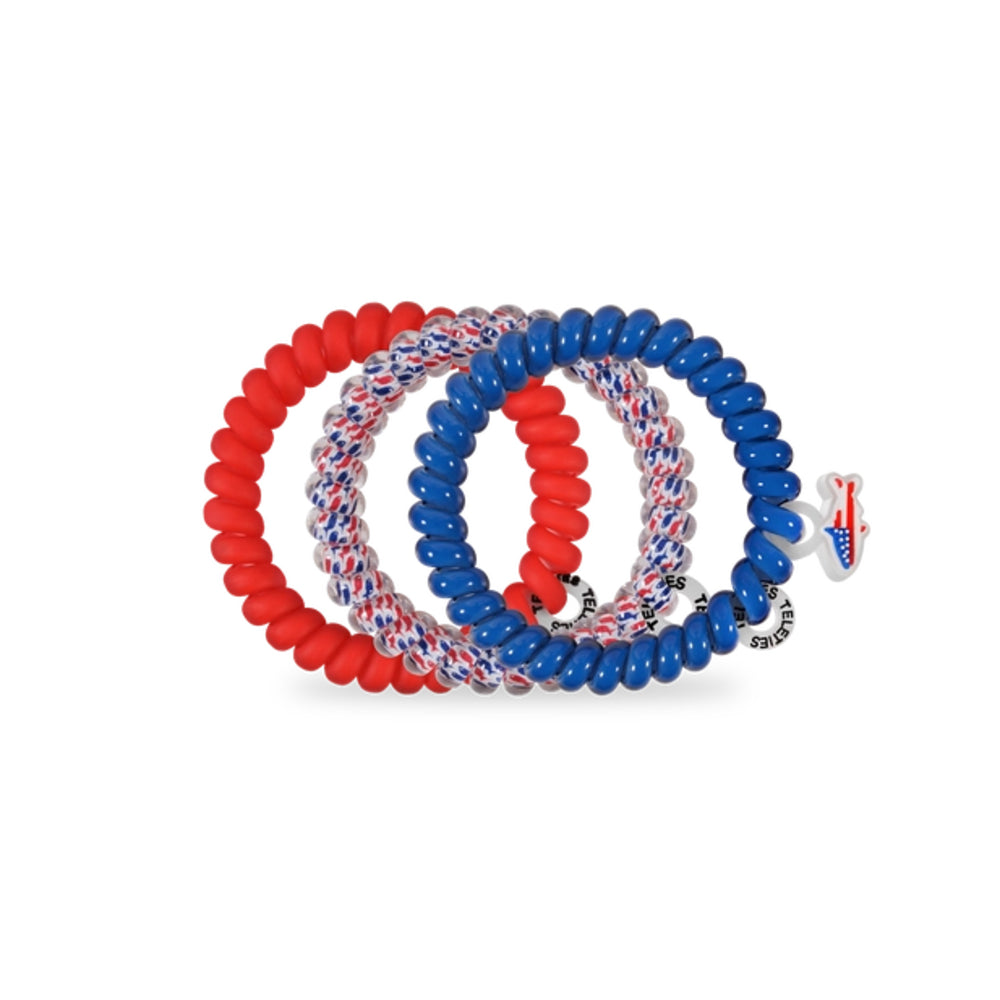 Set of red, white, and blue hair ties on a white background