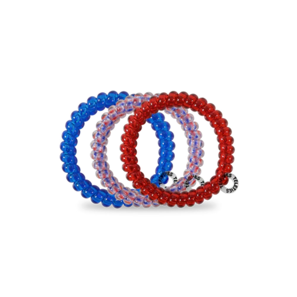 Set of three hair ties in blue, red, and clear on a white background