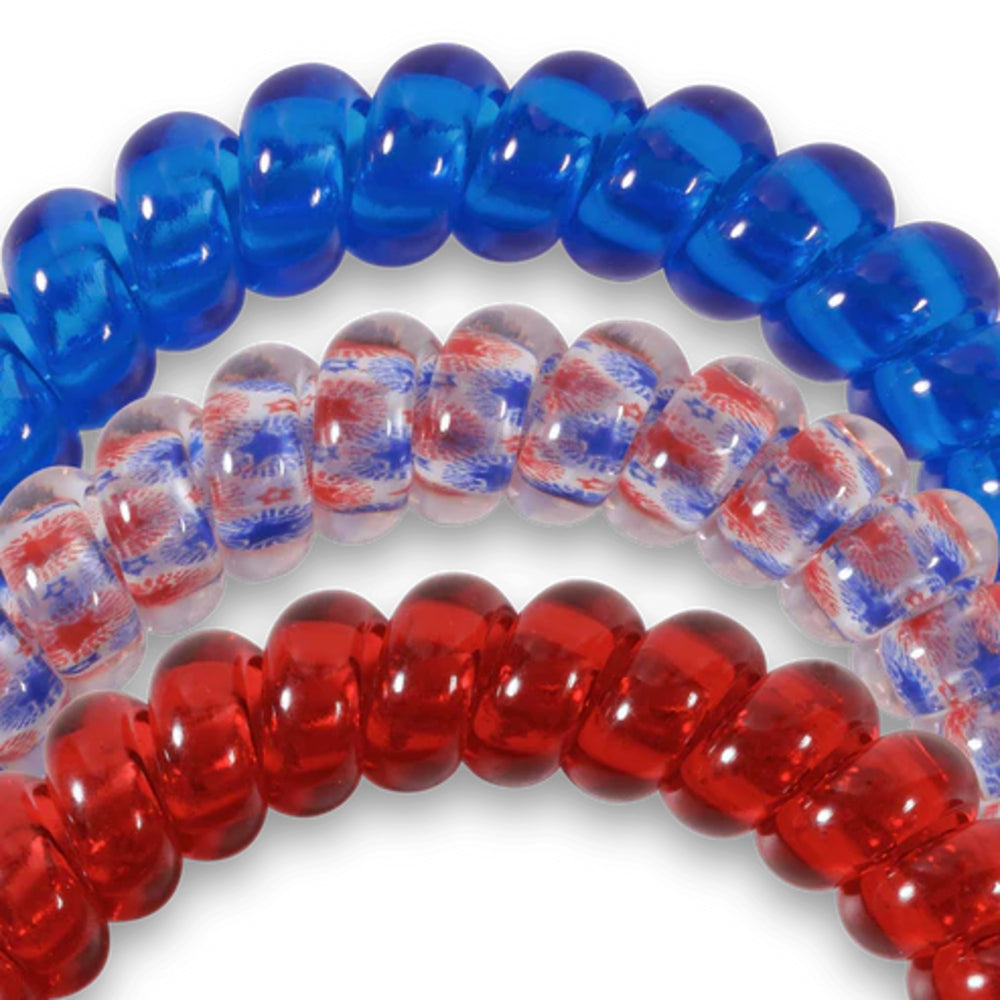Three hair ties in blue, red, and clear with a pattern on a white background