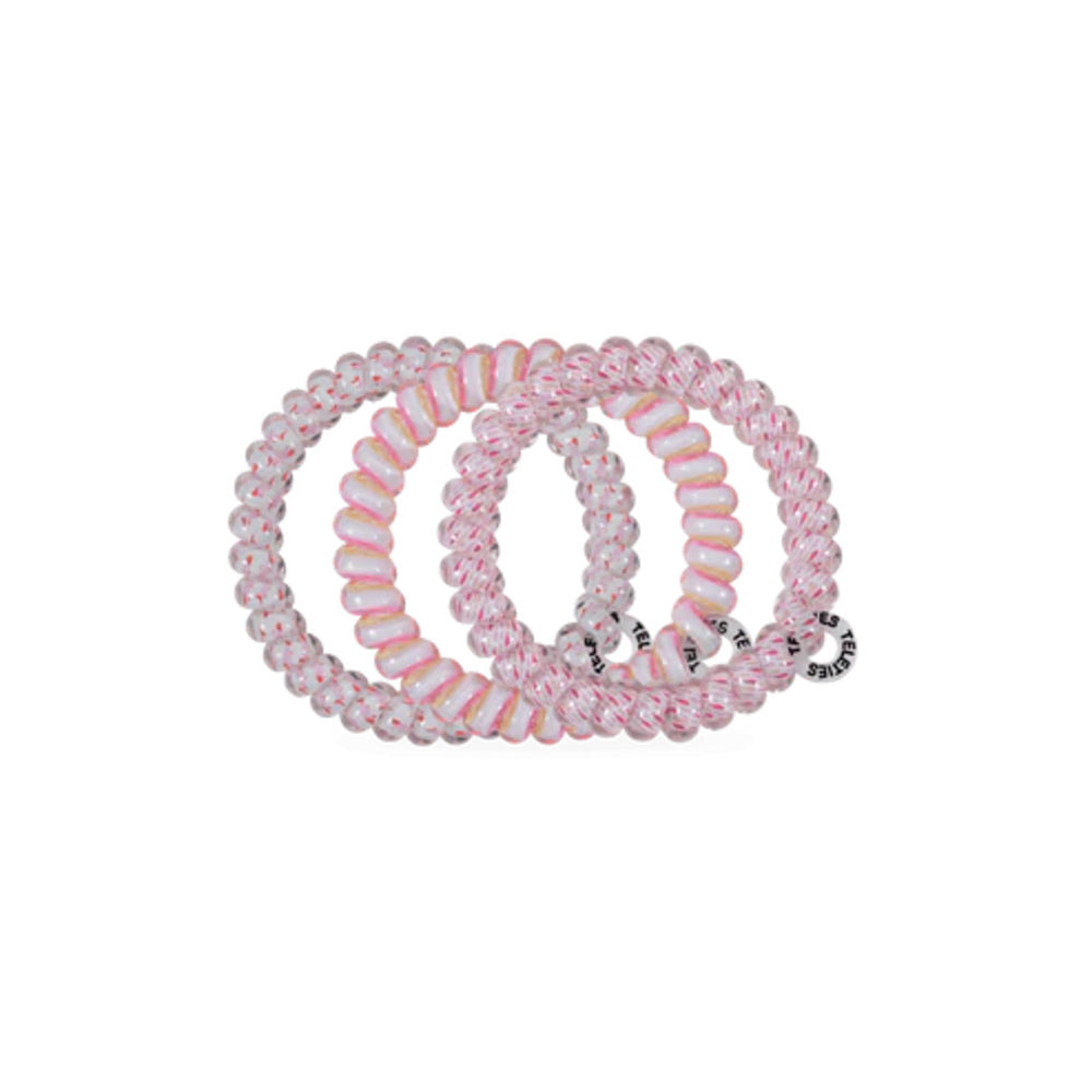 Set of pink and white beaded hair ties on a white background