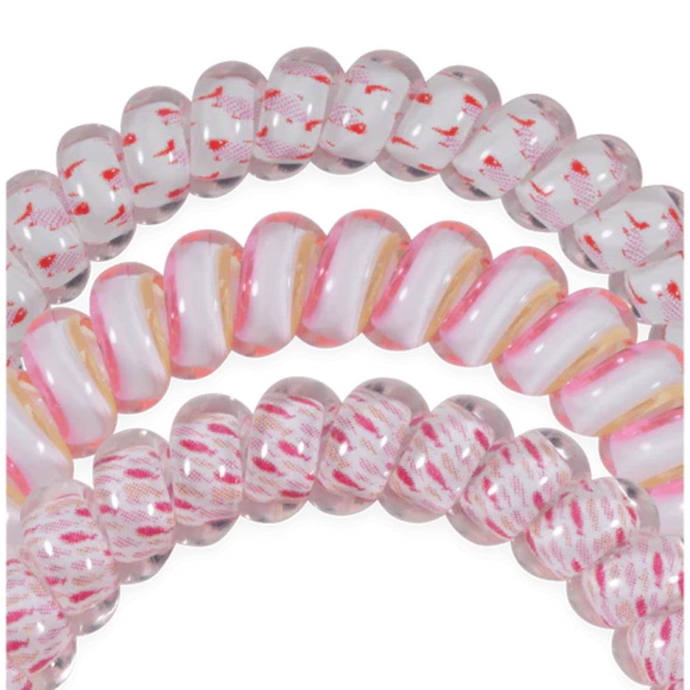Coiled pink and white spiral hair ties with pink design on a white background
