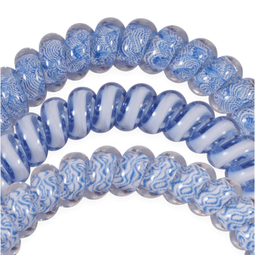 blue and white patterned hair ties on a white background