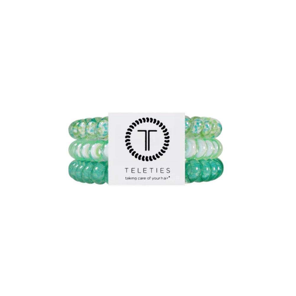 Set of green floral hair ties with a Teleties label on a white background