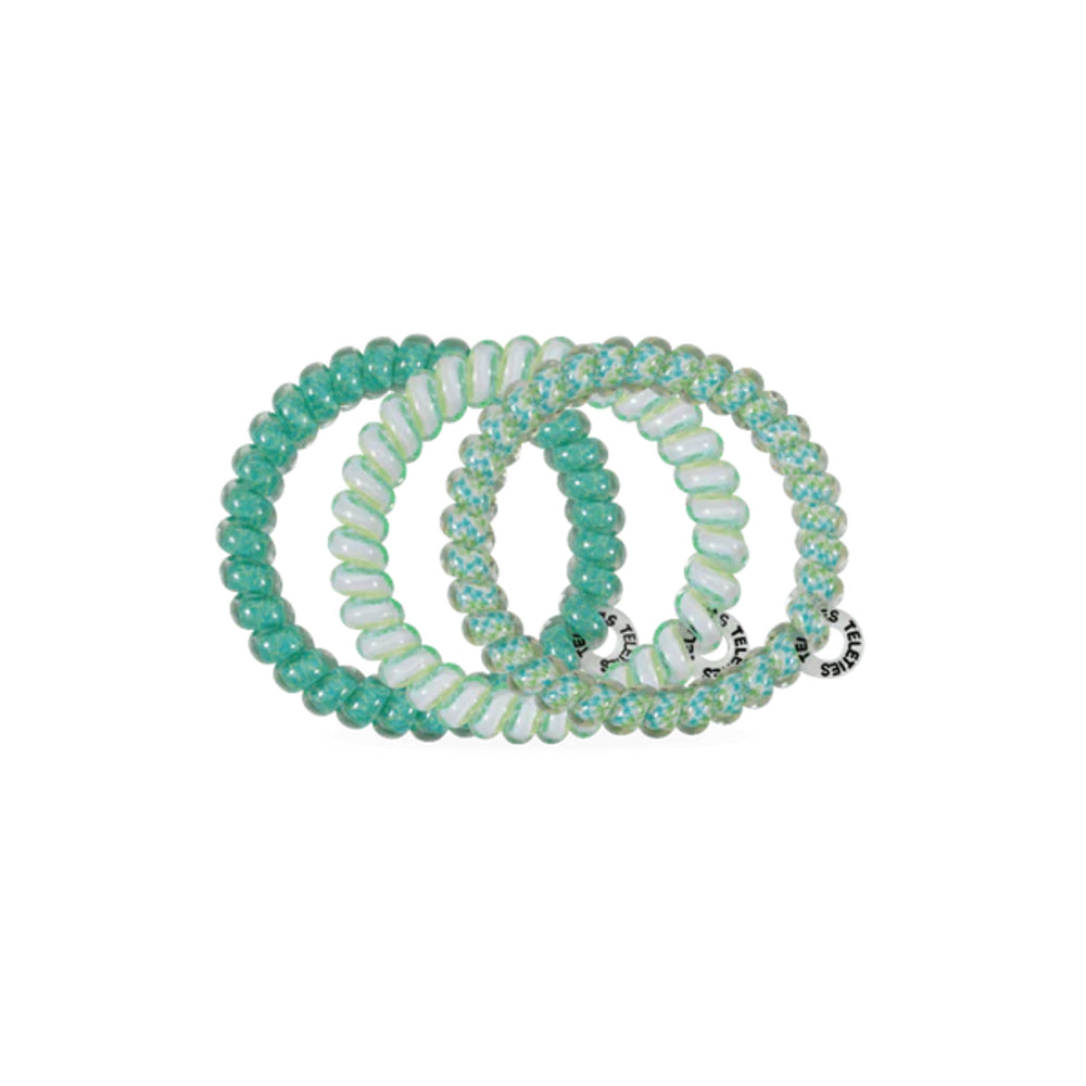 Set of turquoise and white beaded hair ties on a white background