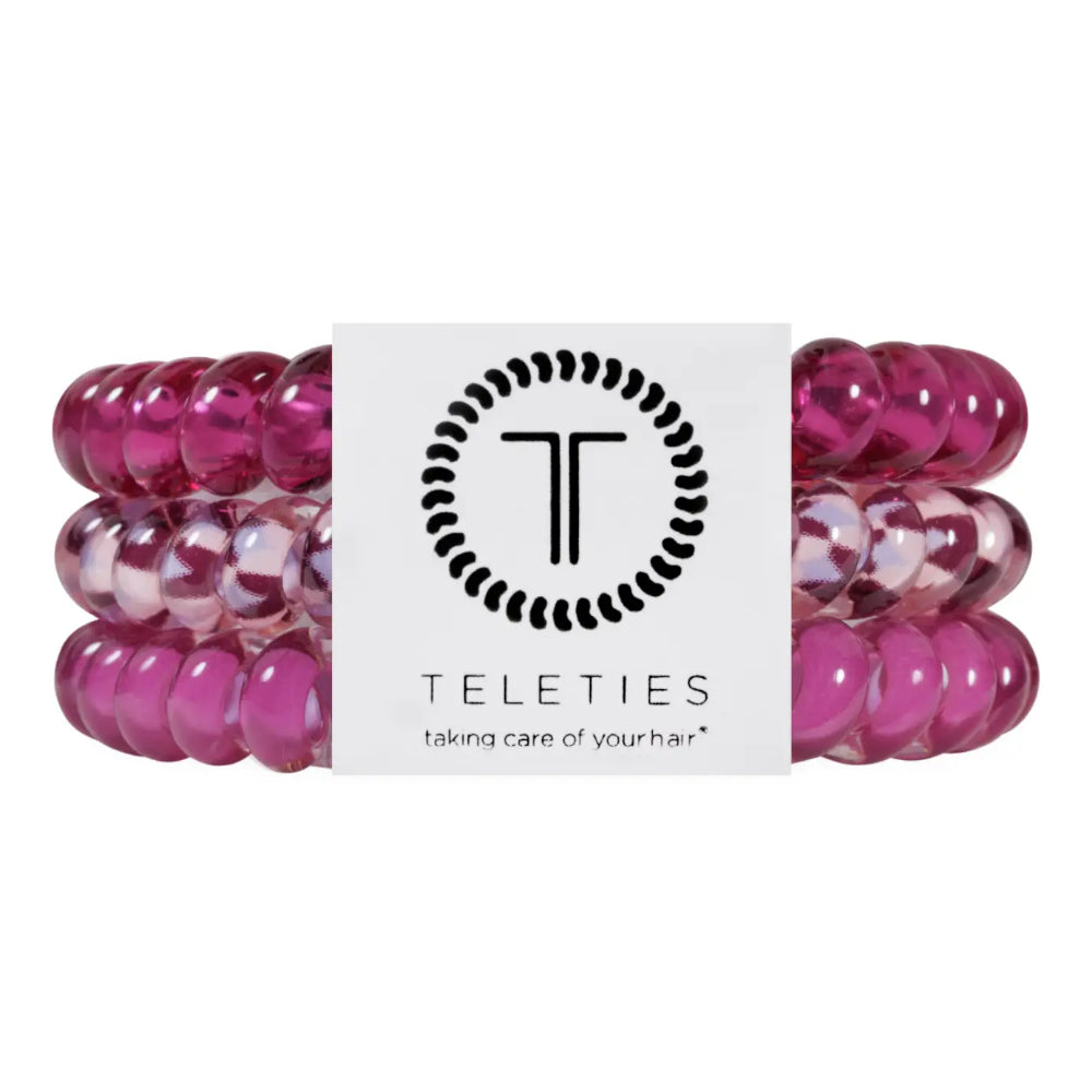 Three pink beaded stretch hair ties with a white Teleties brand label in the center, shown on a plain white background.