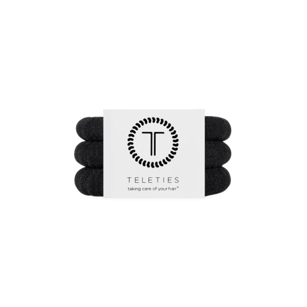 Three black hair ties with a white label featuring the 'Teleties' brand on a white background.