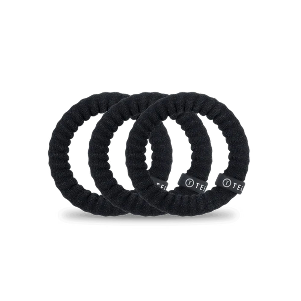 Three black hair scrunchies with a brand logo on a white background