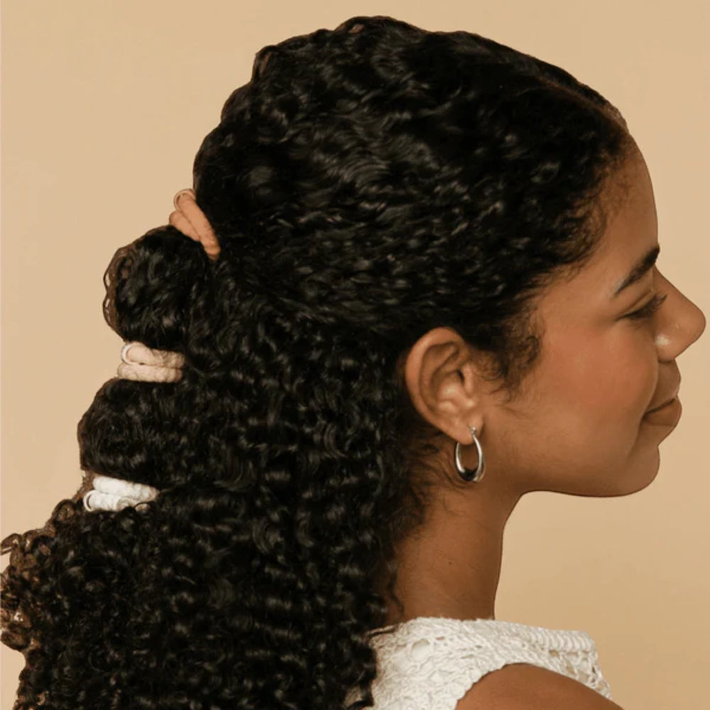 Woman with styled hair on a beige background