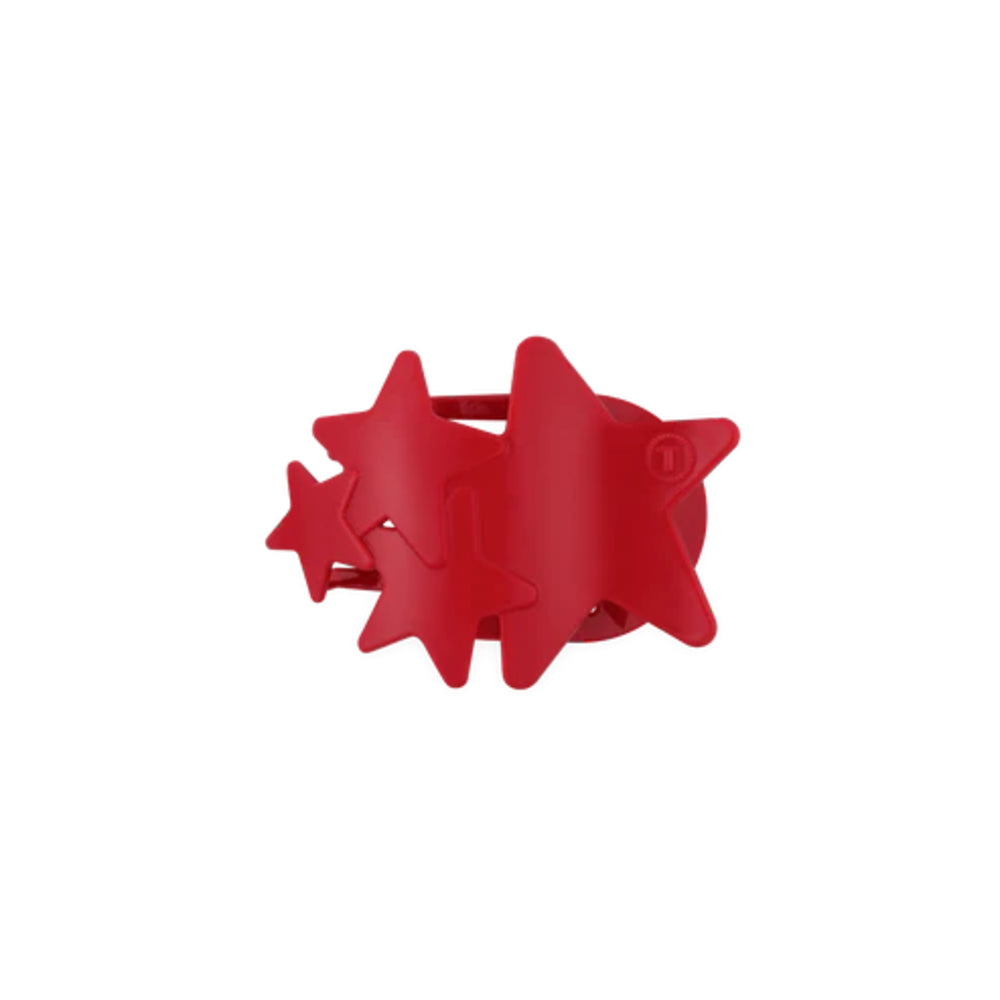 Red star-shaped hair clip on a white background