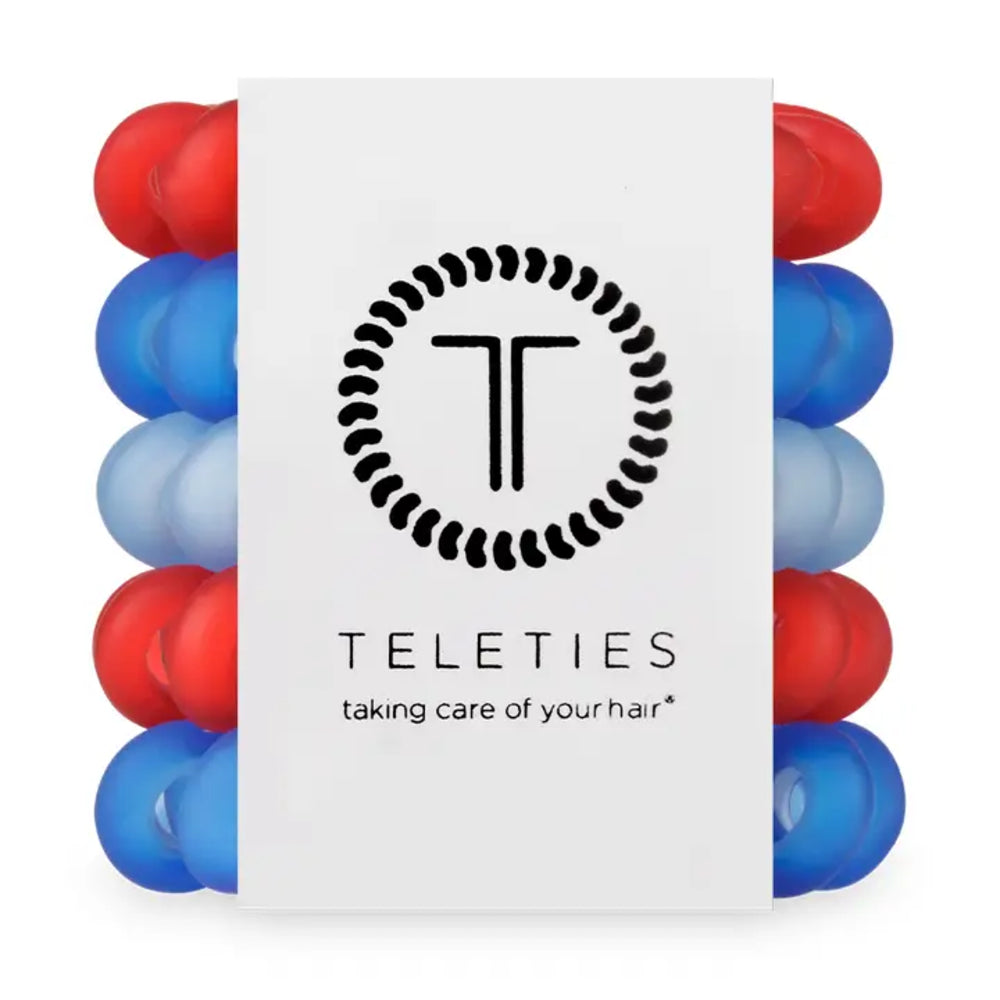 Stack of red and blue hair ties with Teleties logo and branding on a white background
