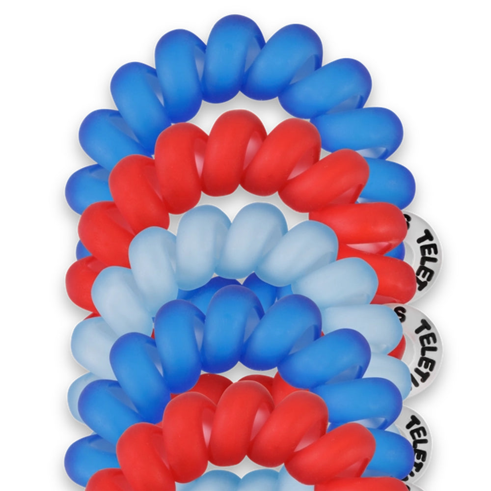 Red, white, and blue spiral hair tie with  branding on a white background