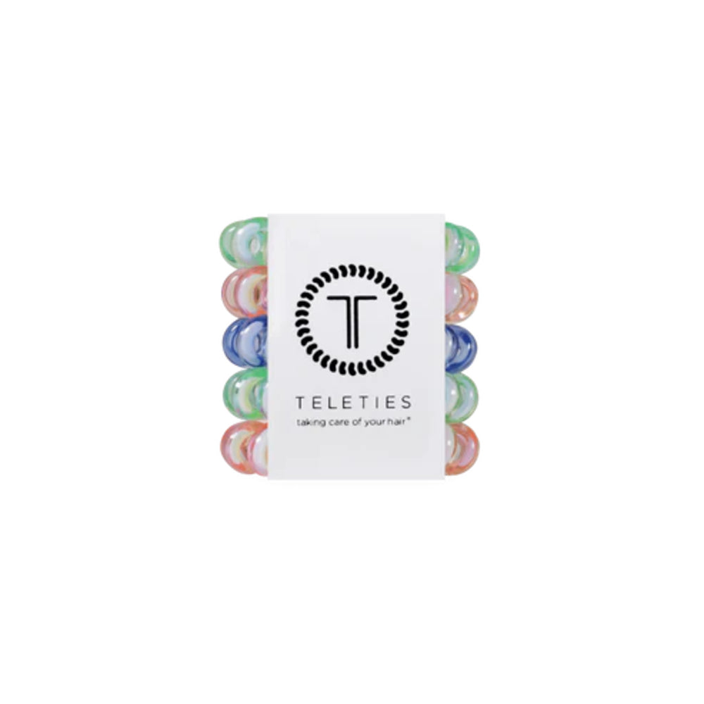Set of colorful hair ties in a Teleties branded box on a white background