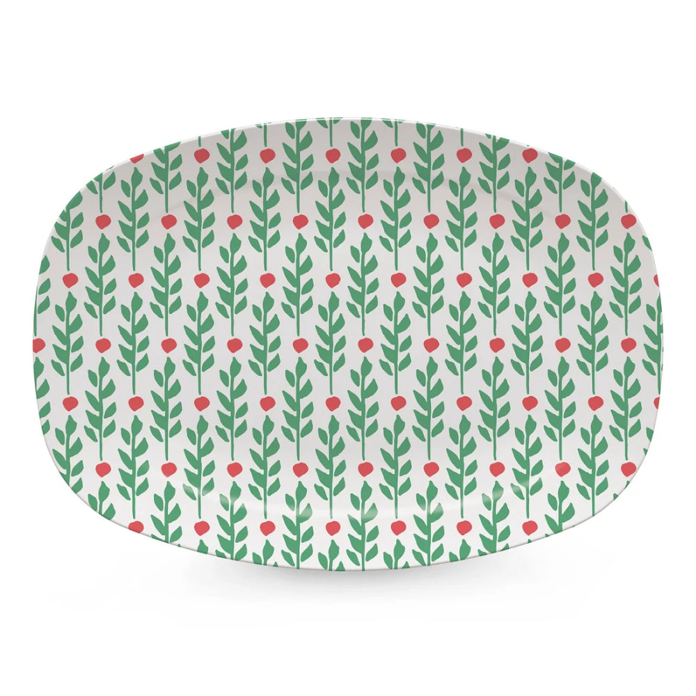 An oval ceramic plate with rounded corners, featuring a repeating pattern of green leafy stems and small red berries on a white background.
