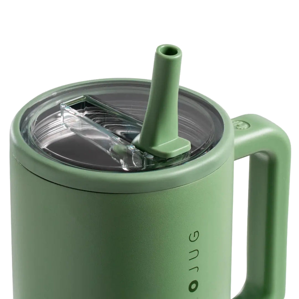 Green mug with straw lid on a white background.
